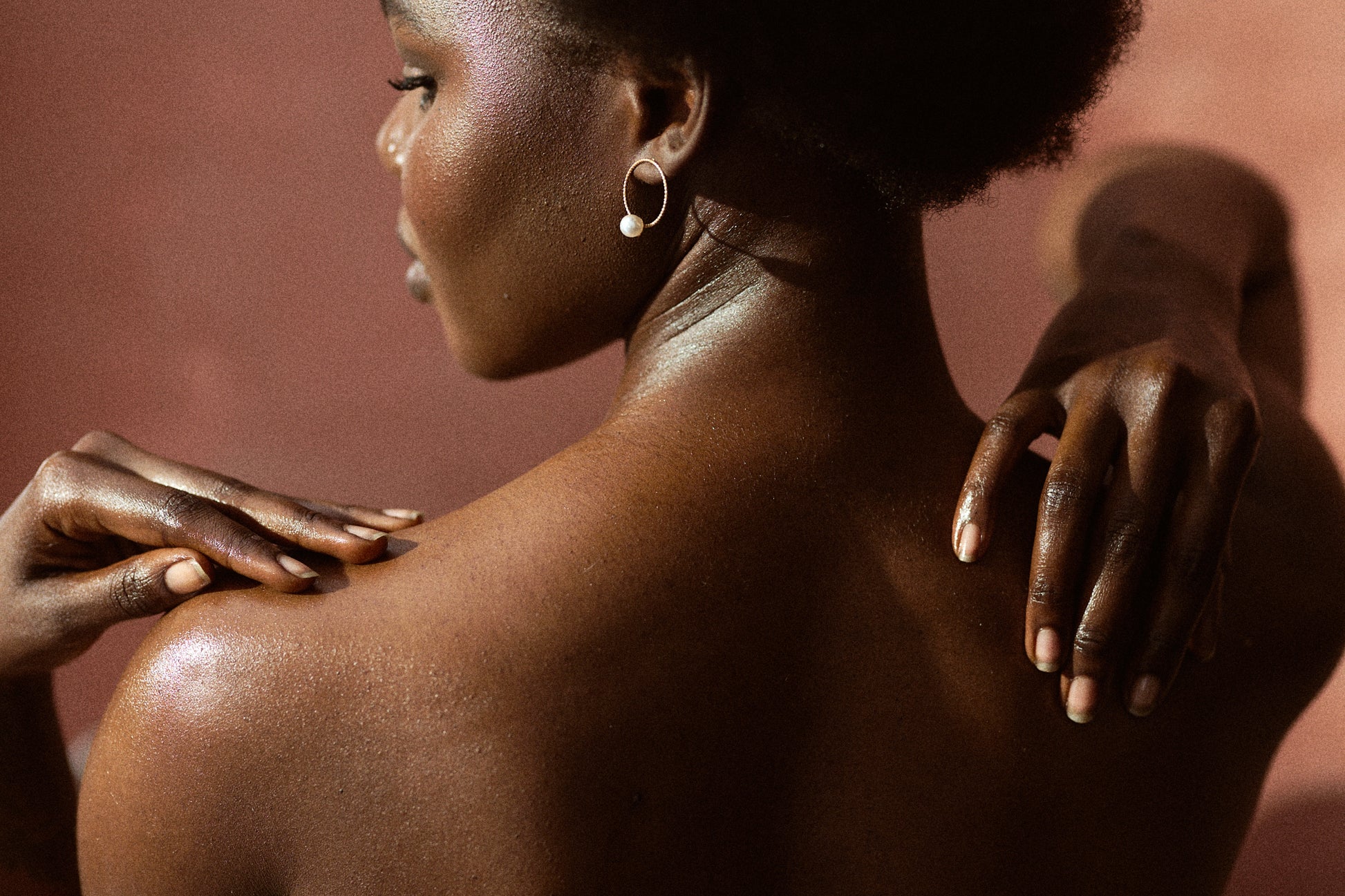 Leer She and Turmeric Soap back and hands of African woman